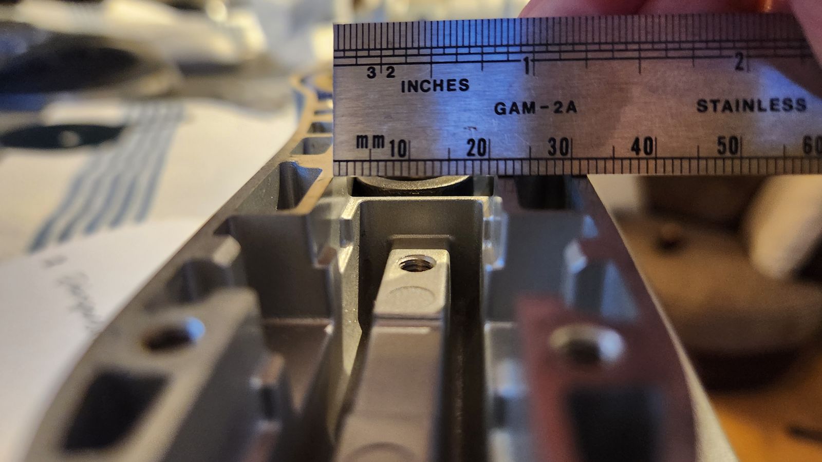 Steel rule measuring a cast aluminium part close up